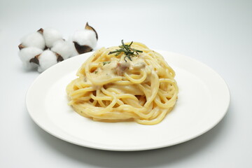 carbonara spaghetti in white ceramic dish