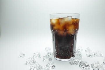 cola in glass with ice on white background
