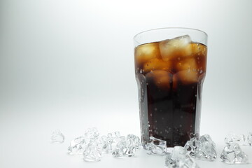 cola in glass with ice on white background