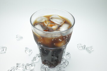 cola in glass with ice on white background