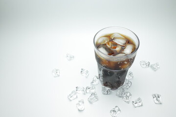 cola in glass with ice on white background