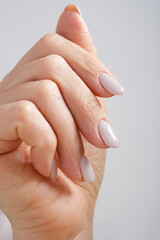 Close-Up Of Woman Fingers With Nail Art. Woman Hand With Pearl Nail Polish