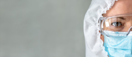 Doctor or nurse in PPE suit and background, panoramic banner