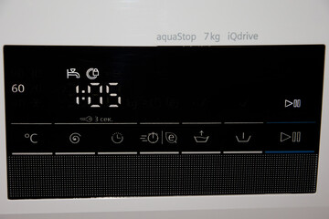 Washing machine touch panel. Washing machine panel display, temperature setting 60 degrees. Laundry abstract programming.