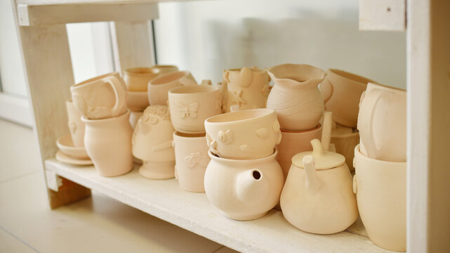 Clay pottery ceramic Products dry on shelf in workshop before coating. handmade and hobby lifestyle concept