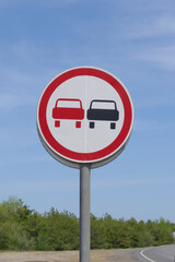 Road sign prohibiting overtaking. Warning to drivers on dangerous section of road