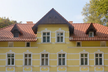 Facade of old mansion with attic. Completed restoration of last century building