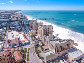 Spring break or Summer vacations in Florida. Ocean beach. Hotels, restaurants and Resorts in US. Blue-turquoise color water. American Coast or shore Gulf of Mexico. Clearwater Beach FL. Aerial view