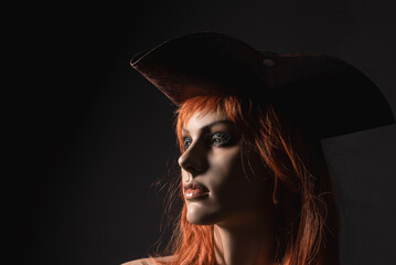 Woman dummy in a pirate hat on a black background.