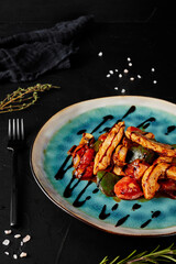 chicken stew with vegetables and pineapples on a black textured background