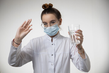 Female doctor GP physician in medical mask recommending pill meds. Healthcare, medicine, treatment, therapy concept