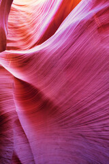 Obraz premium Beautiful red and orange sandstone wall with warm subtle light glow inside Antelope Canyon, Arizona, America