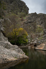 Penha Garcia historic village waterfall and Pego river beach on a cloudy day, in Portugal