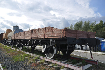 Old open railway platform on rails. Means of transport.