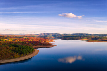 Fototapeta na wymiar Drone aerial view of a lake reservoir of a dam with perfect reflection on the water of the sky in Sabugal, Portugal