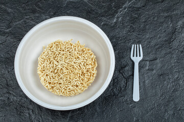 Unprepared noodles on a dark background