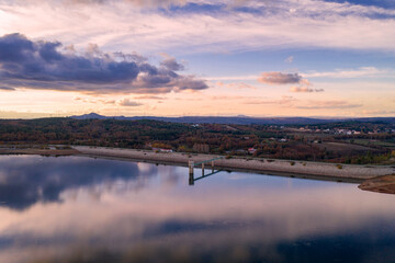 Drone aerial panoramic view of Sabugal Dam lake reservoir with perfect reflection, in Portugal