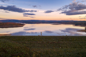 Drone aerial panoramic view of Sabugal Dam lake reservoir with perfect reflection, in Portugal