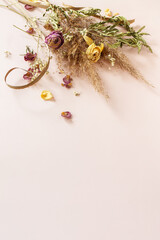 Minimal floral holiday composition. Pampas grass with dried flowers plants bouquet on pink background.