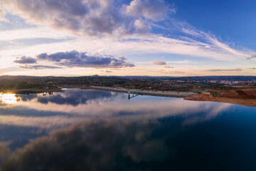 Fototapeta na wymiar Drone aerial panoramic view of Sabugal Dam lake reservoir with perfect reflection, in Portugal