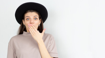 Beautiful excited female covers mouth with astonishment, her eyes are popped, doesnt expect to hear...