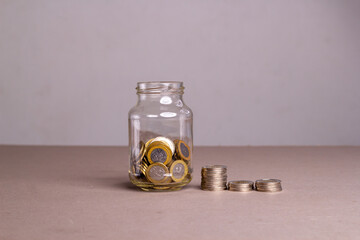 Dominican coin money in a glass jar. Saving the financial concept