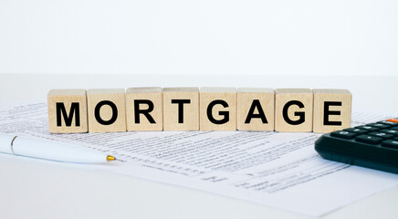 Mortgage word concept written on wooden cubes blocks