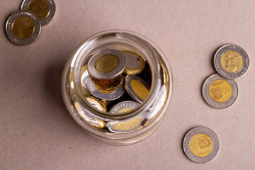 top view dominican coins in a glass jar, financial concept