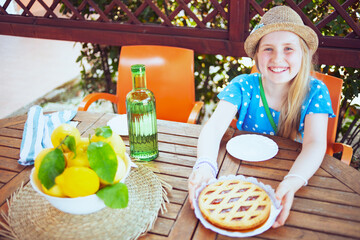smiling modern girl sitting at table having breakfast
