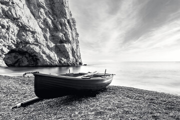 A fishing boat adrift on the beach of the Amalfi coast, black and white mood