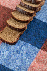 Bunch of rye bread slices on tablecloth