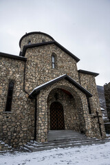 Fototapeta premium gray stone Christian church in the mountains in the Caucasus 