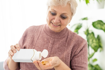 Happy elderly woman holding a glass of milk and pointing isolated on white background