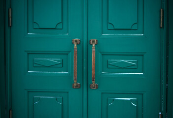 Antique brass knobs on the green doors of the Hermitage