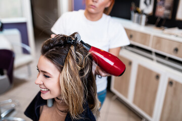 Naklejka premium Young woman enjoying in modern hairsalon. Beauty/fashion concept.