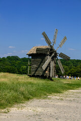 Fototapeta na wymiar Wooden windmills in the village