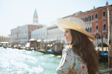 pensive trendy solo tourist woman in floral dress sightseeing