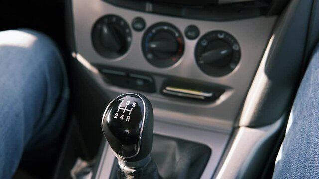 Close-up of a man's hand switches the speed to neutral. Car ride. Manual Transmission.
