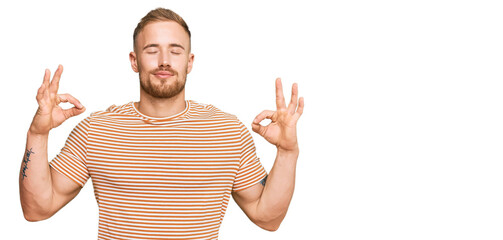 Young irish man wearing casual clothes relax and smiling with eyes closed doing meditation gesture with fingers. yoga concept.