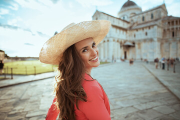 smiling traveller woman in floral dress enjoying promenade