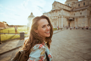 happy elegant woman in floral dress having walking tour