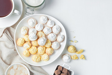 Swiss meringues in a plate on a light background.