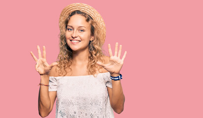 Beautiful caucasian woman wearing summer hat showing and pointing up with fingers number nine while...