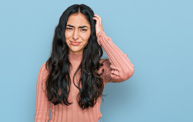 Hispanic teenager girl with dental braces wearing casual clothes confuse and wonder about question....