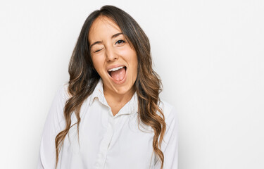 Young brunette woman wearing casual clothes winking looking at the camera with sexy expression,...