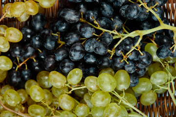 A cluster of mixed grapes in basket, close up