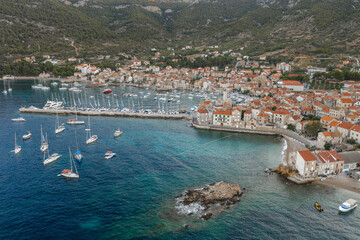 Fototapeta premium Aerial drone shot of Adriatic coastline dock by Komiza on Vis Island in morning before sunrise in Croatia summer