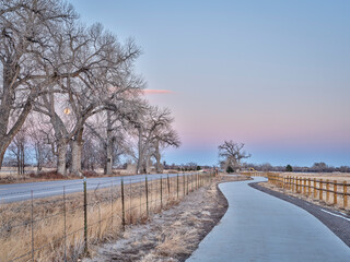 newly constructed bike trail segment in northern Colorado near Windsor, fall or winter scenery at...