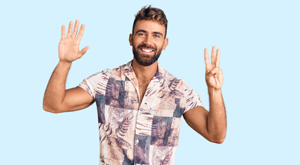 Fototapeta premium Young hispanic man wearing summer clothes showing and pointing up with fingers number eight while smiling confident and happy.