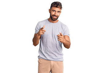 Young hispanic man wearing casual clothes pointing fingers to camera with happy and funny face. good energy and vibes.